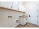 Laundry room with storage cabinets, countertop space, and hookups for a washer and dryer at 15993 W Poinsettia Dr, Surprise, AZ 85379