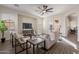 Well-lit living room featuring modern furniture, hardwood floors, and a neutral color palette at 15993 W Poinsettia Dr, Surprise, AZ 85379
