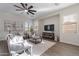 Bright living room with a ceiling fan, modern furniture, and lots of natural light at 15993 W Poinsettia Dr, Surprise, AZ 85379