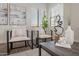 Cozy sitting area featuring stylish chairs, decor, and bright natural light at 15993 W Poinsettia Dr, Surprise, AZ 85379