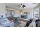 Open-concept living area featuring stylish furnishings, wood floors, and natural lighting at 15993 W Poinsettia Dr, Surprise, AZ 85379