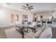 Spacious living area with an open floor plan, modern furniture, and bright lighting at 15993 W Poinsettia Dr, Surprise, AZ 85379