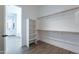 Walk-in closet features wood look flooring, wooden shelving, and additional shelving for shoes at 15993 W Poinsettia Dr, Surprise, AZ 85379