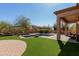 Expansive backyard featuring a private pool, lush grass, brick patio and mountain views at 1633 N Woodruff --, Mesa, AZ 85207