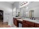 A modern bathroom with double sinks, granite countertops, and a large mirror at 1633 N Woodruff --, Mesa, AZ 85207