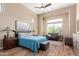 A large bedroom with wood floors, ensuite sitting area, and a ceiling fan at 1633 N Woodruff --, Mesa, AZ 85207