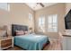 Bedroom with vaulted ceiling, window shutters, coordinated lamps, and a comfortable bed at 1633 N Woodruff --, Mesa, AZ 85207