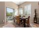 A bright dining room with a modern light fixture and access to the outdoor patio at 1633 N Woodruff --, Mesa, AZ 85207