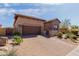 Charming home featuring a stone-accented facade, a tile roof, and a neatly paved driveway with desert landscaping at 1633 N Woodruff --, Mesa, AZ 85207