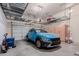 Spacious garage with overhead storage and a blue SUV parked inside, offering ample room for vehicles and storage solutions at 1633 N Woodruff --, Mesa, AZ 85207