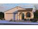 Charming single-story home with a tile roof, arched entryway, and a well-manicured desert landscape at 16800 W Hope Dr, Surprise, AZ 85388