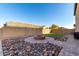 Backyard featuring an outdoor firepit with nice rockwork and a patch of grass at 17474 W Straight Arrow Ln, Surprise, AZ 85387