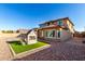 Well-maintained backyard with a charming playhouse and a patio area at 17474 W Straight Arrow Ln, Surprise, AZ 85387