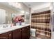 Bathroom featuring a double sink vanity, shower, and decorative accents at 17474 W Straight Arrow Ln, Surprise, AZ 85387