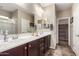 Bathroom featuring a double sink vanity, large mirror, and tile floor at 17474 W Straight Arrow Ln, Surprise, AZ 85387