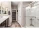 Bathroom with tile floors, walk-in closet, and glass-enclosed shower at 17474 W Straight Arrow Ln, Surprise, AZ 85387