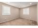 Cozy bedroom featuring neutral walls, carpet, and natural light from shuttered windows at 17474 W Straight Arrow Ln, Surprise, AZ 85387