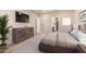 Stylized bedroom featuring sleek furnishings, neutral tones, and an ensuite bathroom at 17474 W Straight Arrow Ln, Surprise, AZ 85387