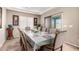 Formal dining room with tray ceiling, large window, and seating for eight guests at 17474 W Straight Arrow Ln, Surprise, AZ 85387