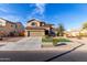 Two-story home featuring a neutral stucco facade, two-car garage, and xeriscaped front yard at 17474 W Straight Arrow Ln, Surprise, AZ 85387