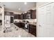 Gourmet kitchen featuring stainless steel appliances, granite countertops, and ample dark wood cabinets at 17474 W Straight Arrow Ln, Surprise, AZ 85387