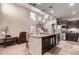 Open-concept kitchen with a large island, stainless steel appliances, and seamless flow to the living space at 17474 W Straight Arrow Ln, Surprise, AZ 85387