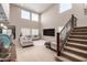 Bright living room with vaulted ceilings, large windows, and a cozy seating area with plush furniture and carpet at 17474 W Straight Arrow Ln, Surprise, AZ 85387