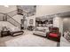 Spacious living room featuring staircase, and open access to kitchen and seating at 17474 W Straight Arrow Ln, Surprise, AZ 85387
