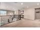Upstairs loft with iron railing, artwork, and neutral-colored walls at 17474 W Straight Arrow Ln, Surprise, AZ 85387