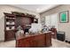 Home office featuring custom cabinetry, desk space, and natural light at 17474 W Straight Arrow Ln, Surprise, AZ 85387