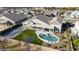 An aerial view shows the home's luxurious backyard featuring a pool, sports court, and green space at 20061 E Cherrywood Ct, Queen Creek, AZ 85142