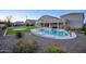 Beautiful backyard with a pool, spa, sport court, covered patio, and lush landscaping for entertaining at 20061 E Cherrywood Ct, Queen Creek, AZ 85142