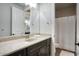 Bathroom features a granite countertop, dark cabinetry, and a shower with curtain at 20061 E Cherrywood Ct, Queen Creek, AZ 85142