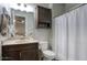 Well-lit bathroom showcases dark cabinetry, a granite countertop, and a shower with curtain at 20061 E Cherrywood Ct, Queen Creek, AZ 85142