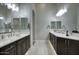 Bright bathroom with double vanity, white countertops, wood cabinets, and tiled floor at 20061 E Cherrywood Ct, Queen Creek, AZ 85142