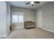 Neutral bedroom with plantation shutters, a ceiling fan, and a wooden crib at 20061 E Cherrywood Ct, Queen Creek, AZ 85142
