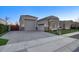 Long driveway leading to multiple garages, with stone accents and mature landscaping at 20061 E Cherrywood Ct, Queen Creek, AZ 85142