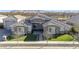 Aerial view of a stone facade home with a well-manicured lawn, complemented by mountain views at 20061 E Cherrywood Ct, Queen Creek, AZ 85142