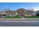 Beautiful single-story home featuring a stone facade, well-manicured lawn, and inviting entrance at 20061 E Cherrywood Ct, Queen Creek, AZ 85142