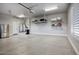 Spacious garage with epoxy floor, storage racks, utility sink, and water heater for convenience at 20061 E Cherrywood Ct, Queen Creek, AZ 85142