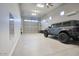 Spacious garage with epoxy floors, a mirror, a car, and a garage door at 20061 E Cherrywood Ct, Queen Creek, AZ 85142