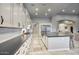 Well-appointed kitchen featuring stainless steel appliances, shaker cabinets, quartz counters, subway tile, and an island with a sink at 20061 E Cherrywood Ct, Queen Creek, AZ 85142