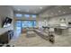 Bright living room with comfortable seating, large windows, and open to the modern kitchen at 20061 E Cherrywood Ct, Queen Creek, AZ 85142