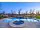 Inviting pool with a waterfall feature, hot tub, basketball hoop and trampoline for outdoor fun at 20061 E Cherrywood Ct, Queen Creek, AZ 85142