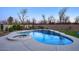 Inviting pool with waterfall feature, spa, basketball hoop, lush landscaping, and privacy wall at 20061 E Cherrywood Ct, Queen Creek, AZ 85142