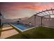 Backyard with a pool, neutral tile, grass, and a pergola with string lights at 21255 W Ashland Ave, Buckeye, AZ 85396