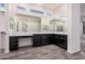 This bathroom features dual sinks, walk in closet and wood look tile at 21255 W Ashland Ave, Buckeye, AZ 85396
