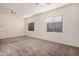 This large bedroom offers neutral carpeting, ceiling fans, and two windows for plenty of natural light at 21255 W Ashland Ave, Buckeye, AZ 85396