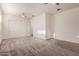 Spacious bedroom with neutral carpet, ceiling fan, and closet with double doors at 21255 W Ashland Ave, Buckeye, AZ 85396