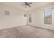 This bedroom features neutral carpeting and three windows that provide plenty of natural light at 21255 W Ashland Ave, Buckeye, AZ 85396